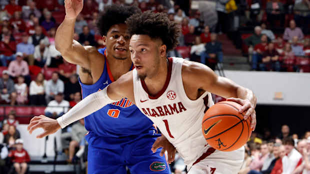 Feb 21, 2024; Tuscaloosa, Alabama, USA; Alabama Crimson Tide guard Mark Sears (1) drives the baseline around Florida Gators guard Zyon Pullin (0) during the first half at Coleman Coliseum. Mandatory Credit: Butch Dill-USA TODAY Sports  